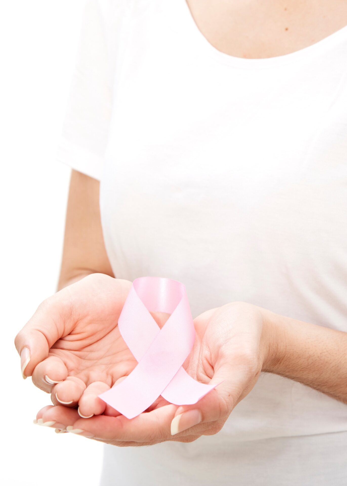 woman holding a pink ribbon